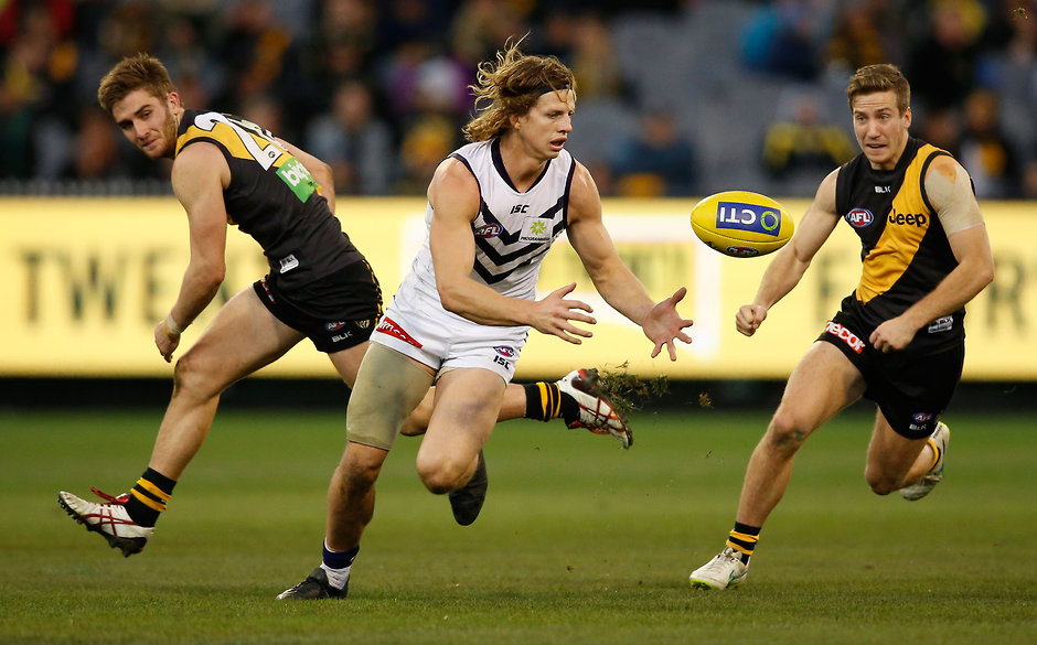 AFL 2015 Rd 17 - Richmond v Fremantle MELBOURNE, AUSTRALIA - JULY 25: Nat Fyfe of the Dockers in action ahead of Anthony Miles (left) and Kane Lambert of the Tigers during the 2015 AFL round 17 match between the Richmond Tigers and the Fremantle Dockers at the Melbourne Cricket Ground, Melbourne, Australia on July 25, 2015. (Photo by Adam Trafford/AFL Media)